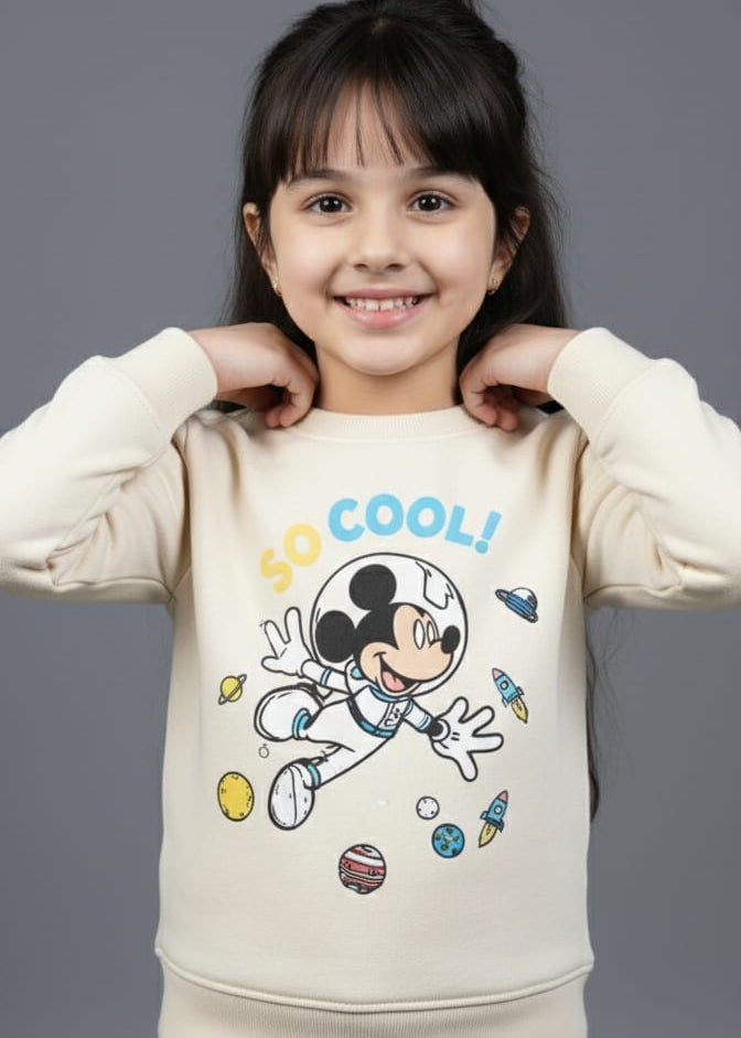 Child wearing a cream sweatshirt with a cartoon character and 'So Cool!' text on a gray background