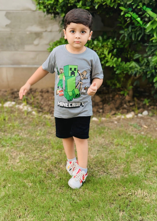 Child wearing a Minecraft t-shirt outdoors on grass