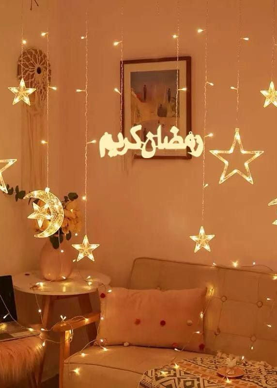 Decorative string lights with stars and moons hanging in a room.