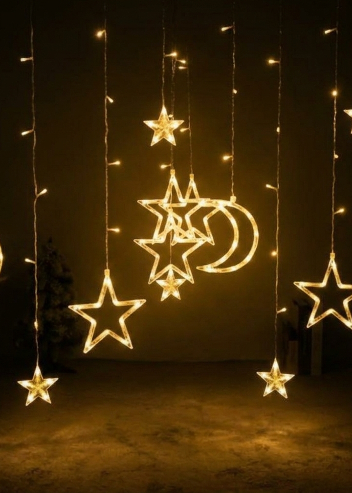 Decorative string lights shaped like stars and moons hanging against a dark background.