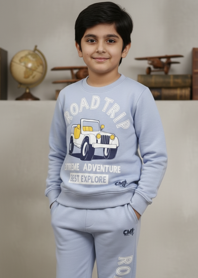 Child wearing a light blue 'Road Trip' themed tracksuit with matching shoes.