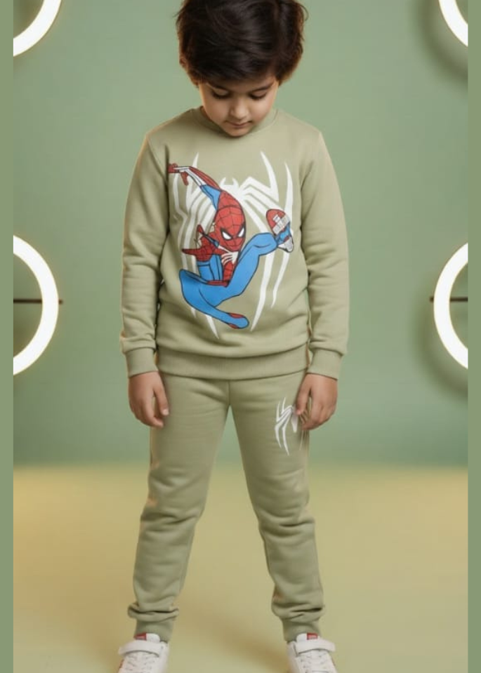 Child wearing a Spider-Man themed tracksuit against a green background