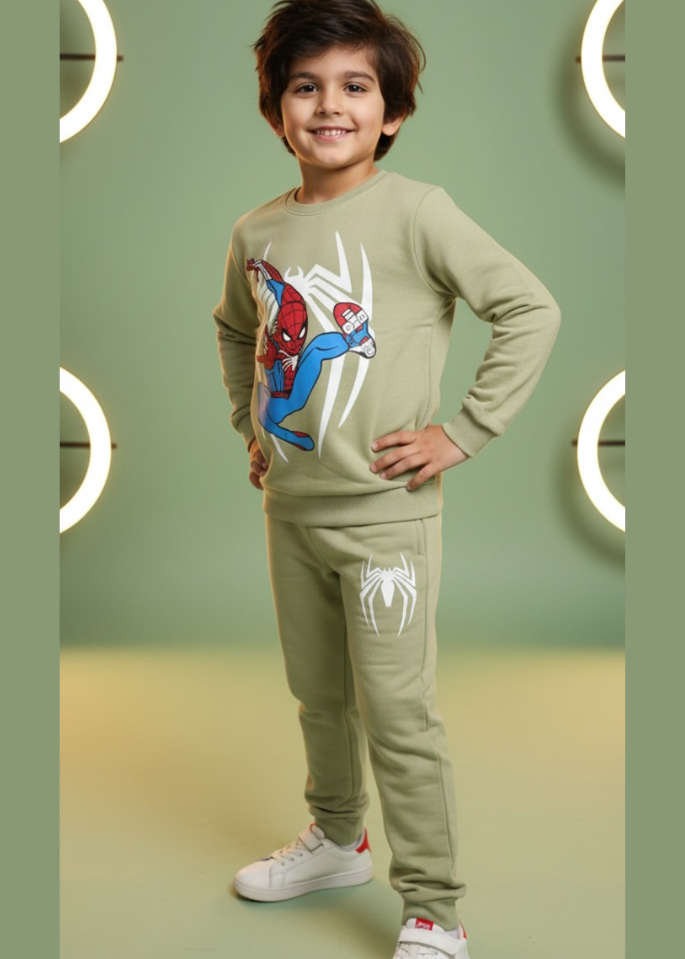 Child wearing a Spider-Man themed tracksuit against a green background