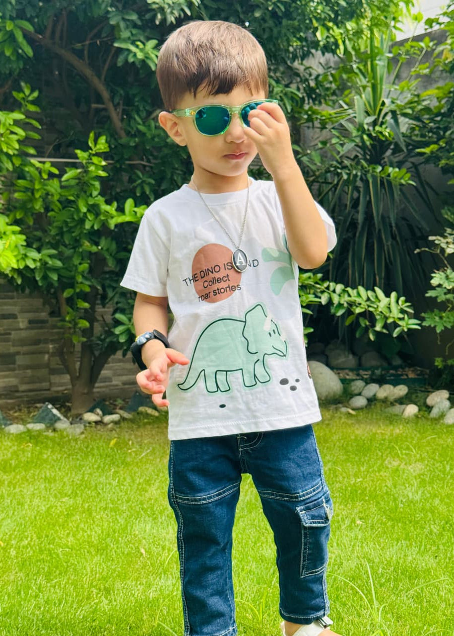Child wearing a t-shirt with a dinosaur design outdoors