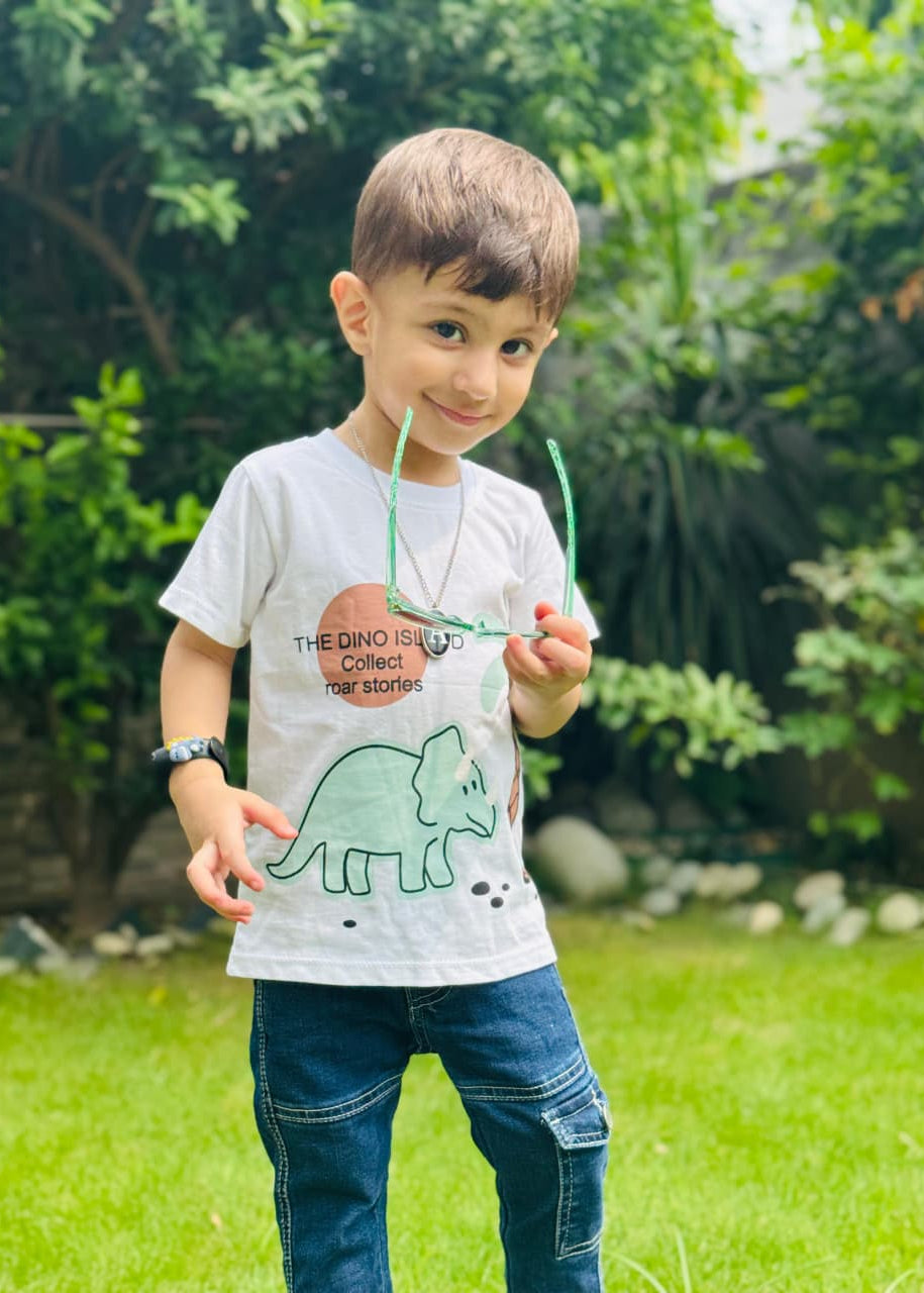 Child wearing a t-shirt with a dinosaur design outdoors