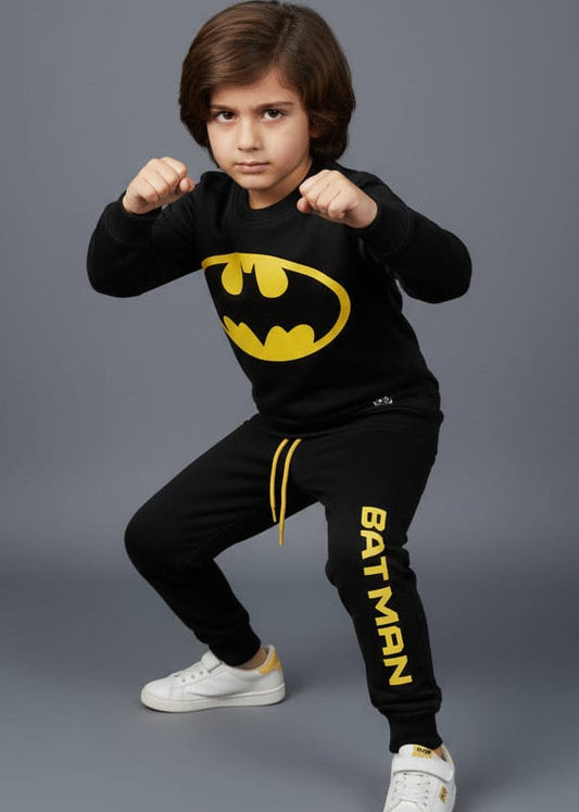 Child wearing a Batman-themed outfit with a gray background