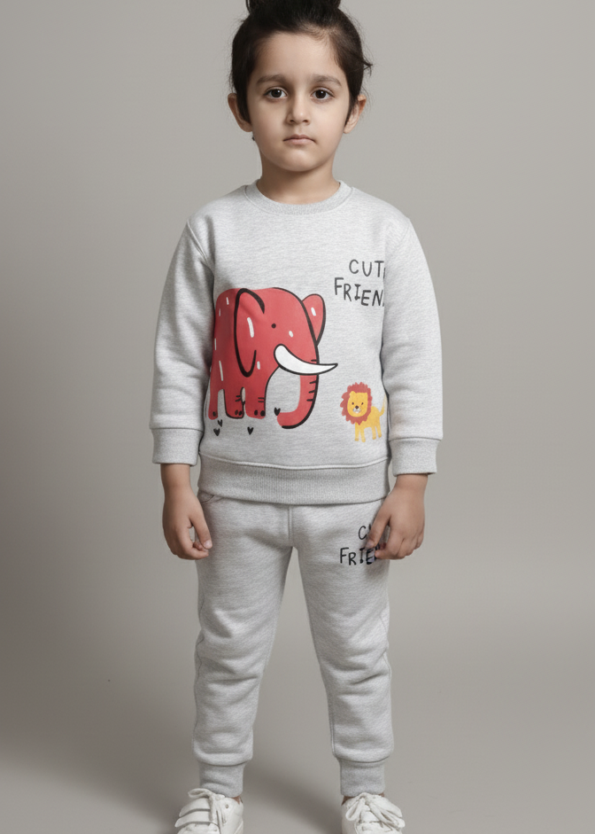 Child wearing a white sweatshirt with a red graphic and text, standing against a plain background