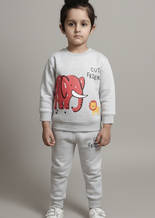Child wearing a white sweatshirt with a red graphic and text, standing against a plain background