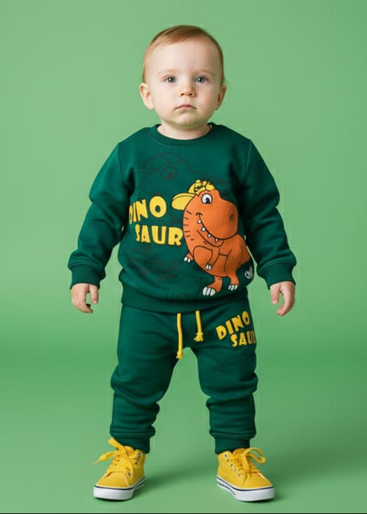 Child wearing a green dinosaur-themed outfit with yellow shoes on a green background