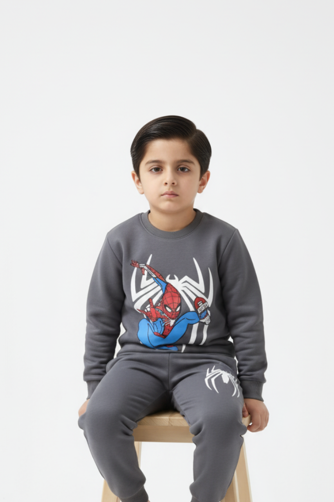 Child wearing a Spider-Man themed gray sweatshirt and pants on a white background