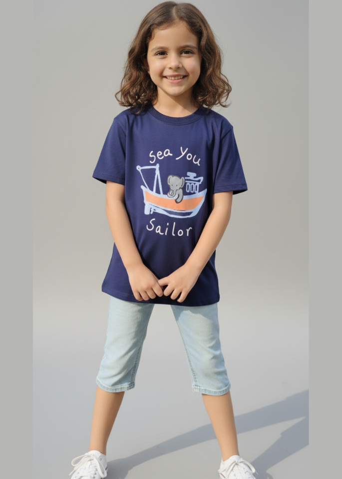 Child wearing a navy blue t-shirt with a graphic design on a gray background
