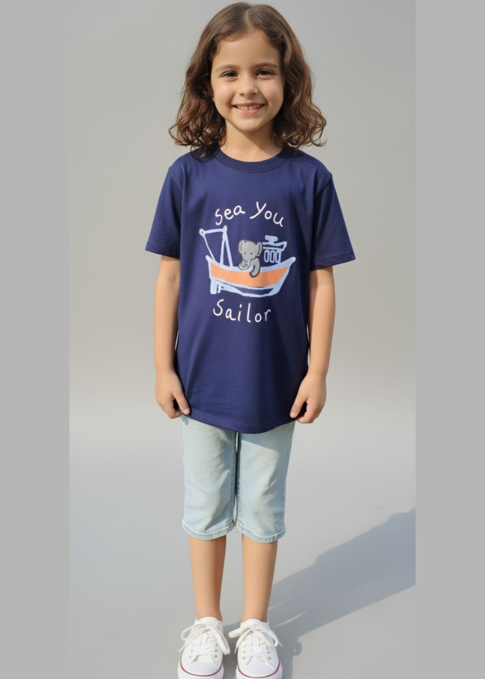 Child wearing a navy blue t-shirt with a graphic design on a gray background