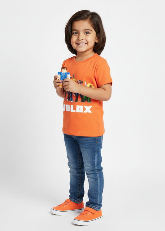 Child wearing an orange t-shirt with a toy in hand on a white background