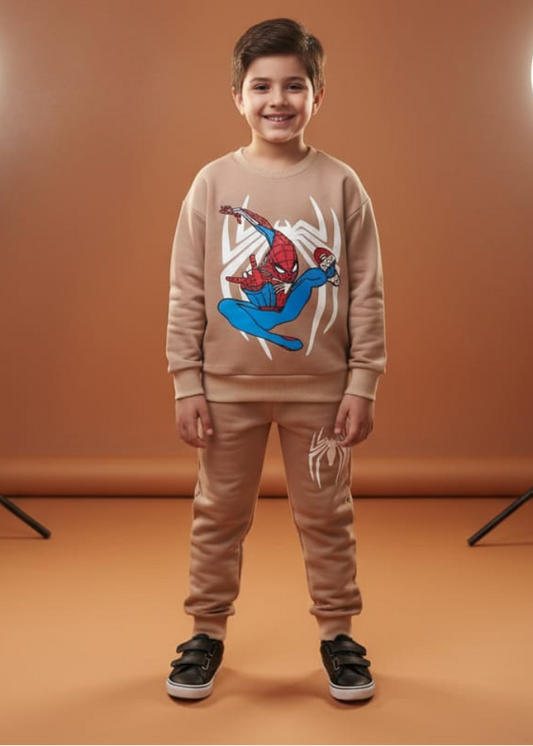Child wearing a beige Spider-Man sweatshirt and pants on a brown background